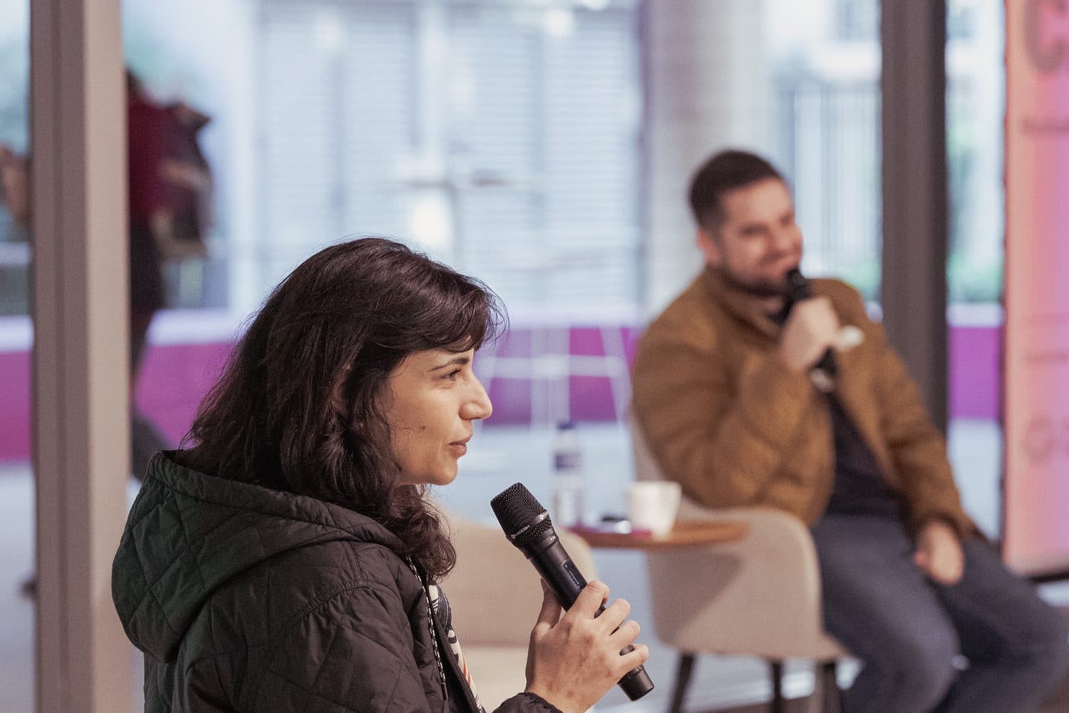 A speaker on stage taking a question from the room.
